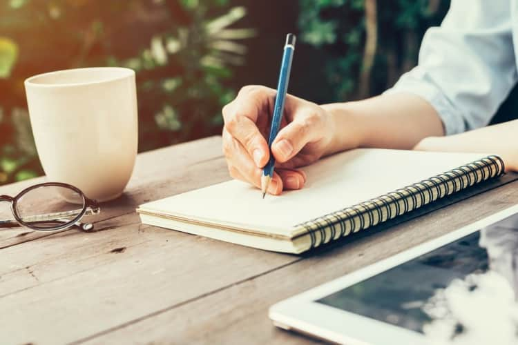 Human Hand With Pencil and a NoteBook